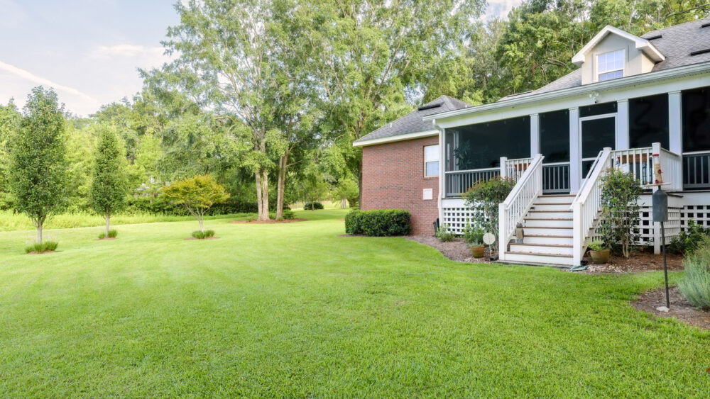 Back of Colonial Brick House with Landscaped Yard